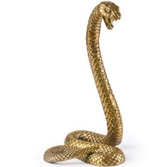 a gold snake statue sitting on top of a white surface