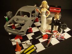 a wedding cake topper sitting on top of a black and white checkered table