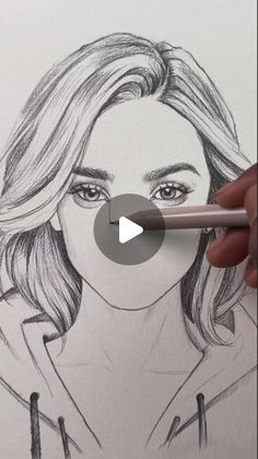 someone is drawing a woman's face with a pencil