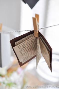 an open book hanging from a clothes line