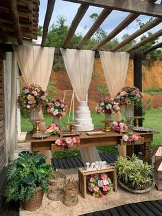 a table with flowers and cake on it in the middle of an outdoor patio area