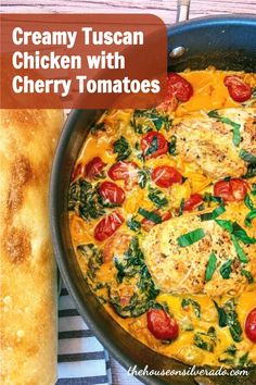 creamy tuscan chicken with cherry tomatoes and spinach in a skillet next to bread