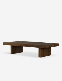 a wooden table sitting on top of a white floor