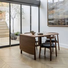 a dining table with two chairs and a bowl on it