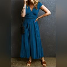 This Long Dress Is Suitable For Different Occasions. A Trendy High Waist Look With Shirred Details At The Back. It Has A Sexy V-Neck, Short Sleeves And A Flared Maxi Length Blue V-neck Maxi Dress For Night Out, Blue V-neck Maxi Dress For Date Night, Blue Non-stretch Dress For Night Out, Non-stretch Blue Dress For Night Out, Blue Surplice Neckline Maxi Dress For Evening, Blue Maxi Dress With Surplice Neckline For Evening, Fitted Blue V-neck Maxi Dress, Blue V-neck Midi Dress Solid Color, Blue Solid Color Dress For Date Night