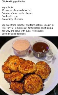 a white plate topped with fried food next to dipping sauce