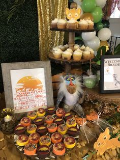 an assortment of cupcakes and desserts on a table