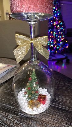 a wine glass with a christmas tree in it