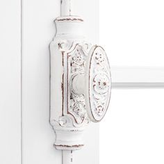 an old fashioned white door handle on a white wall