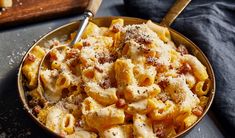 a bowl filled with pasta and sauce on top of a table