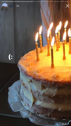 a birthday cake with lit candles on it