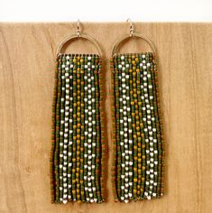 Tvpushnik in the Choctaw language translates to basket. This design is inspired by traditional Choctaw river cane basketry. These hand-beaded earrings with an unfinished open half-round brass top have thirteen fringes with a basket weave diamond motif. Tvpushnik contains 676 delicate glass beads in each earring and is 3" long tradition gloss black, white, neon red, matte turquoise on sterling silver-plated findings, sterling silver ear wires flora gloss forest green, deep pink, eucalyptus, on ra Choctaw Language, Ribbon Skirts, Deep Pink, Opal White, Brick Red, Gloss Black, Raw Brass, Shop Earrings, Basket Weaving