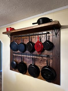 pots and pans are hanging on the wall