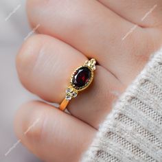 Gemstone : Natural Red Garnet  Metal : 9K Gold / 14K Gold / 18K Gold / 925S Silver Gemstone Shape and Size : Oval 8x6 MM Gemstone Shape and Size : Round 1.50 MM Gemstone Weight : 1.30 Cts Metal Weight :  3.00 Gram ACCEPT CUSTOM SERVICE: 1. Accept change main stone type, size : Oval  8x6 MM 2. Accept change other material : This jewelry can also be made in solid gold (14K white/rose/yellow gold...) Please contact me if you have special requests. Thanks for your visiting! Garnet Gold Ring, January Birthstone Rings, Red Garnet Ring, Engagement Rings For Women, Engagement Ring For Her, Garnet And Gold, Ring Birthstone, Rings Engagement, Rose Yellow