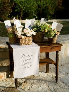 flowers are placed in baskets on a table