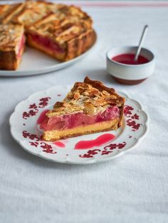 a piece of pie sitting on top of a white plate next to a cup and saucer