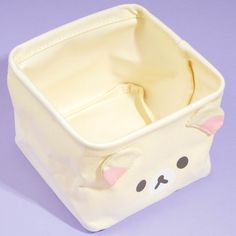 a small toy storage bag with a bear face on it's front and side