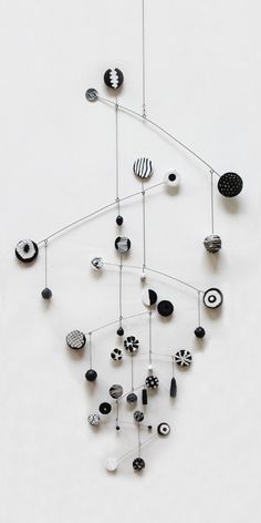 a sculpture made out of various objects on a white surface with black and white accents