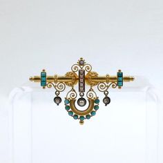 A very fine Victorian Etruscan Revival brooch.  In 14k gold with both filigree decoration and granulated and wire work decoration throughout. It is bezel set with small turquoise cabochons and seed pearls.    Suspended from the top bar is an arc with bezel set round turquoise cabochons and three pearl set pendants.  Simply a finely made Revivalist brooch!  Date: 19th Century  Overall Condition: It is in overall good, as-pictured, used estate condition with some very fine & light surface scratche Victorian People, Pearl Brooch, Pearl Set, Seed Pearl, Vintage Victorian, Wire Work, Gorgeous Jewelry, Dream Jewelry, 19th Century