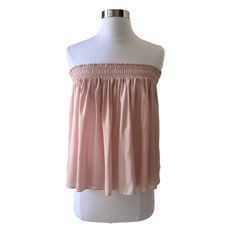 Color: Light Pink Style: Smocked Ruffle Top Semi Sheer Measurements: Bust 16.5” Un-Stretched, Armpit To Armpit Length 17” Fabric: 100% Lyocell Machine Wash Condition: New Chic Sleeveless Smocked Top With Elastic Neckline, Flowy Smocked Top For Daywear, Feminine Spring Strapless Tops, Feminine Strapless Top For Spring, Casual Strapless Off-shoulder Top For Spring, Spring Sleeveless Tops With Elastic Neckline, Feminine Sleeveless Blouse With Smocked Back, Chic Sleeveless Blouse With Smocked Bodice, Chic Bandeau Smocked Top For Day Out