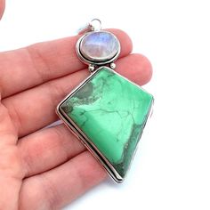 This large, kite shaped apple green variscite and rainbow moonstone pendant is set bezel set in sterling silver. Wear on a chain, leather or satin cord. If you  like large unique jewelry,  this is perfect for you! Metal Content: Sterling Silver -tested Measurements Length including bail:  3 1/8" (80mm) Width:  1 5/8" (41mm) Bail opening: 12mm x 6mm Weight: 25 Grams Stamps: none noted Condition: Excellent Pre-Owned Items will ship in a gift box or pouch Each piece is thoroughly examined and refin Bohemian Jewelry With Rectangular Gemstone Pendant, Nickel-free Chrysoprase Jewelry Gift, Chrysoprase Jewelry With Large Stone For Gift, Bohemian Sterling Silver Jewelry With Square Pendant, Unique Green Square Pendant Jewelry, Green Moonstone Jewelry With Natural Stones, Green Moonstone Jewelry For Healing, Handmade Green Rectangular Pendant Jewelry, Bohemian Sterling Silver May Birthstone Jewelry