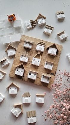 several pieces of wood are arranged on top of each other, including small wooden houses