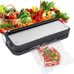 a sandwich maker with fresh vegetables and meat in front of it on a white background