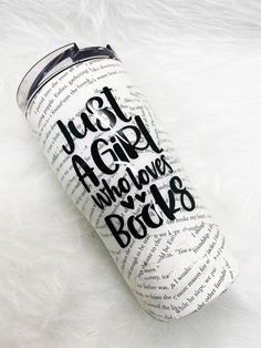 a white and black tumbler with the words just girl who loves books on it