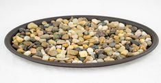 a bowl filled with rocks on top of a white table