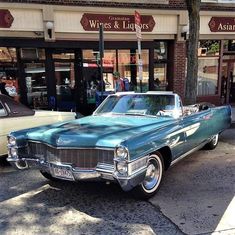 an old car parked in front of a store