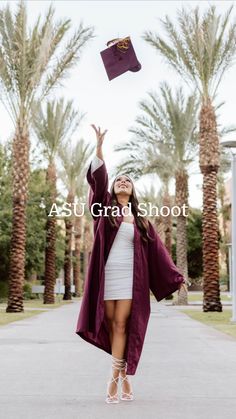 a woman is throwing her graduation cap in the air