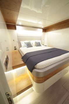 there is a bed that has been made in the boat's cabin and it appears to be floating