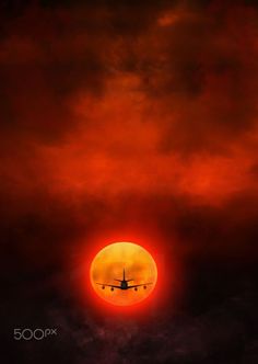 an airplane is flying in front of the sun