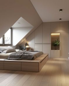 a bed sitting in the middle of a bedroom under a slanted ceiling next to a window