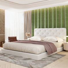 a bedroom with a large bed and green striped wallpaper on the walls, along with a chair