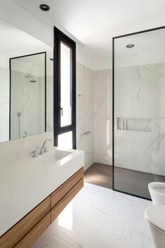 a bathroom with white marble walls and floors