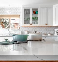 a kitchen counter with pots and pans on it