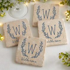 three personalized stone coasters sitting on top of a table