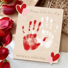 a valentine's day card with handprints and hearts on it next to tulips