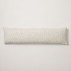 a white pillow on a white wall