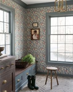 a room with blue walls and floral wallpaper