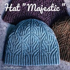 two knitted hats sitting next to each other on top of a cement surface with the words hat magic written above them