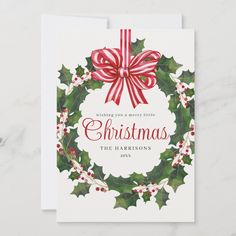 a christmas card with holly wreath and bow