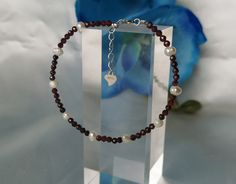 "Prices quoted are total prices. VAT is not reported due to small business status in accordance with § 19 UStG.  This beautiful handmade bracelet consists of 50 natural garnet gemstones and 9 genuine freshwater pearls. The radiant red of the garnet stones and the shimmering white beads harmonise perfectly. The bracelet offers a subdued and delicate but special design. ♥️ The garnet is a stone of the month of January. ♥️ It stands for manifestation and self-esteem.  The bracelet is adjustable in Sterling Silver Bracelet With Round Beads And Lobster Clasp, Handmade Adjustable Red Sterling Silver Bracelet, Adjustable Red Pearl Bracelet Gift, Adjustable Red Pearl Bracelet As A Gift, Handmade Sterling Silver Pearl Bracelet Gift, Business Status, Pearls Bracelet, Radiant Red, Freshwater Pearl Bracelet