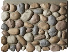 a stone wall with several different colored rocks on it