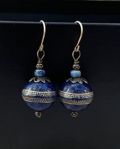 Midnight blue spheres flecked with gold mimic the mystique and elegance of Lapis Lazuli without the weight. Luxurious yet lightweight, they have an equator of gold gilding. The earrings dangle 1.75 inches and are accented by delicate Czech crystal faceted beads and bronze lacework cap beads.  The french hook earwires are 14k goldfill and are perfect for those with any metal sensitivities. Petite Earrings, Unique Handmade Earrings, Pine Lake, Casual Earrings, Fall Earrings, Czech Crystal, Gold Gilding, Pretty Earrings, Delicate Earrings