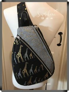 a black and gold giraffe print purse on a mannequin head stand