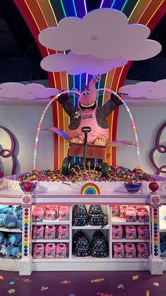 a toy store display with various toys on the shelf and in the background is a rainbow - lit ceiling