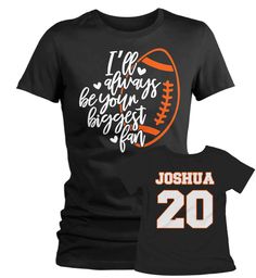 "Women's Personalized Football T Shirt Biggest Fan Shirts Custom Football Mom Shirt Personalized Football Shirt This personalized football shirt is perfect for your son or daughter's, niece, nephew, granddaughter or grandson's next game! The front will read 'I'll always be your biggest fan ' with a football and the back will be personalized with the name and number of your choice in a large athletic font. Made of soft ring spun cotton and includes a cotton muslin drawstring gift bag. Personaliza Black Tops With Name Print For Fan Gear, Football Season Fan Gear Shirt, Football Season Team Name Sports Fan Shirt, Football Season Team Name Fan Shirt, Pre-shrunk Football Season Sports Fan Shirt, Pre-shrunk Sports Fan Shirt For Football Season, Sports Fan Short Sleeve Shirt For Football Season, Short Sleeve Shirt For Football Season Sports Fans, Sporty Football Season Fan Gear Shirt