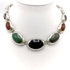 This is a stunning Taxco sterling silver necklace featuring onyx, jasper, turquoise and another unidentified polished black striped stone. This piece is in the style of Enrique Ledesma. The silver is impeccably blended with the stones. Clearly, with this level of attention to detail and skill, one may assume this piece was indeed done by a true master.  Taxco silver jewelry has a fascinating and rich history. The indigenous people of Taxco were using silver long before the arrival of the Spanish in the Americas. This indigenous society mined silver and used it to make gifts and offerings to the Aztec gods. The people of Taxco utilized their ingenuity and creativity centuries before the arrival of a man named William Spratling. However, it was indeed this man who put into motion what collec Aztec Gods, Taxco Silver Jewelry, Nature Necklace, Indigenous People, Multi Stone, Sterling Silver Necklace, This Man, Stone Necklace, Fashion Fashion